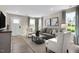 Warm and inviting living room with comfortable seating, stylish decor, and plenty of natural light from large windows at 408 Grand Silo Rd, Garner, NC 27603