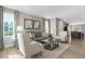 Bright and airy living area with comfortable seating, stylish decor, and natural light streaming through large windows at 408 Grand Silo Rd, Garner, NC 27603