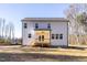 The rear exterior of the home features a covered porch and ample windows for natural light at 412 Longleaf Glen Lane, Zebulon, NC 27597
