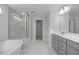 Bathroom featuring soaking tub, tiled shower, double vanity and luxury finishes at 412 Longleaf Glen Lane, Zebulon, NC 27597