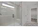 The bathroom features tiled shower with a glass door and built-in bench at 412 Longleaf Glen Lane, Zebulon, NC 27597
