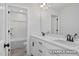 This bathroom has double sinks, black hardware and white cabinets providing a spa-like experience for personal care at 412 Longleaf Glen Lane, Zebulon, NC 27597