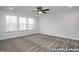 Bedroom with carpet, ceiling fan, and large windows that fill the room with natural light at 412 Longleaf Glen Lane, Zebulon, NC 27597