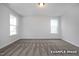 Spacious carpeted bedroom with two windows offering plenty of natural light and a comfortable, inviting atmosphere at 412 Longleaf Glen Lane, Zebulon, NC 27597