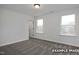 Cozy bedroom featuring neutral walls, carpeted floors and two windows letting in an abundance of natural light at 412 Longleaf Glen Lane, Zebulon, NC 27597