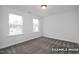 This bedroom has two windows offering plentiful natural light and carpeted floors for optimal comfort at 412 Longleaf Glen Lane, Zebulon, NC 27597