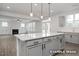 Open-concept kitchen with a large island, pendant lighting, and views of the living room fireplace at 412 Longleaf Glen Lane, Zebulon, NC 27597