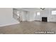 Spacious living room with wood floors, a fireplace, and built-in cabinets at 412 Longleaf Glen Lane, Zebulon, NC 27597