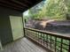This back porch has a wood floor, a wooden lattice surround and a view of a wooded area at 4120 Sedgewood Dr # 106, Raleigh, NC 27612