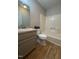 Neutral bathroom with a tub/shower, a granite vanity and modern wooden floors at 4120 Sedgewood Dr # 106, Raleigh, NC 27612