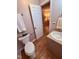 This bathroom features wood floors, a toilet with a decorative bowl, and a vanity with a granite countertop at 4120 Sedgewood Dr # 106, Raleigh, NC 27612