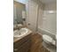 Bathroom with a granite sink and vanity, white door, and a shower/tub combo at 4120 Sedgewood Dr # 106, Raleigh, NC 27612