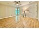Bright bedroom with wood floors, a ceiling fan, two windows and a stylish floor lamp at 4120 Sedgewood Dr # 106, Raleigh, NC 27612