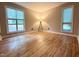 A light and airy bedroom with wooden-style floors and two bright windows at 4120 Sedgewood Dr # 106, Raleigh, NC 27612