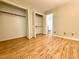 Spacious walk-in closet with bi-fold doors, shelving, and wooden floors leading to the bathroom at 4120 Sedgewood Dr # 106, Raleigh, NC 27612