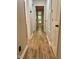 Hallway featuring luxury vinyl plank flooring with white painted doors and neutral walls at 4120 Sedgewood Dr # 106, Raleigh, NC 27612