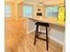 A kitchen counter and bar stool overlook the living room with natural light from exterior view at 4120 Sedgewood Dr # 106, Raleigh, NC 27612
