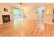 Open living room with a ceiling fan, fireplace, and sliding door to patio with exterior views at 4120 Sedgewood Dr # 106, Raleigh, NC 27612