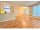 Open concept living room with wood flooring, half wall and windows to the exterior at 4120 Sedgewood Dr # 106, Raleigh, NC 27612