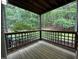 Private outdoor porch surrounded by green trees and with a wooden-slat fence at 4120 Sedgewood Dr # 106, Raleigh, NC 27612
