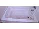 A clean white tub with a faucet and a silver handle at 4120 Sedgewood Dr # 106, Raleigh, NC 27612