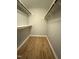 Walk-in closet with wood style flooring, shelving, and racks for storage at 4120 Sedgewood Dr # 106, Raleigh, NC 27612