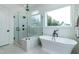 Luxurious bathroom features a glass-enclosed shower, soaking tub, and stylish tile work at 46 Addison Pond Ct, Zebulon, NC 27597