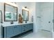 Bathroom with dual sink vanity, wooden framed mirrors and modern fixtures, providing a serene retreat at 46 Addison Pond Ct, Zebulon, NC 27597
