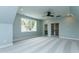 Bonus room with ample lighting and a ceiling fan, also has painted french doors at 46 Addison Pond Ct, Zebulon, NC 27597