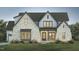 Elegant gray brick home with multi-level gables, porch, and lush landscaping at 46 Addison Pond Ct, Zebulon, NC 27597