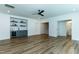 Spacious living area boasts a wet bar, modern ceiling fan, and hardwood floors at 46 Addison Pond Ct, Zebulon, NC 27597