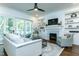 Cozy living room with fireplace, built-in shelving, and sliding glass doors to the patio at 46 Addison Pond Ct, Zebulon, NC 27597