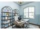 Home office with a wooden desk, metal shelves and a chair, offering an inspiring work environment at 46 Addison Pond Ct, Zebulon, NC 27597