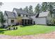 Backyard view of a two-story house with a covered patio and large grassy area at 476 Mollie Meadow Dr, Zebulon, NC 27597