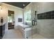 Luxurious bathroom showcasing tub, glass shower, and marble tile at 476 Mollie Meadow Dr, Zebulon, NC 27597