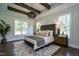 Stunning bedroom featuring wood beams, chandelier, and views of the surrounding landscape at 476 Mollie Meadow Dr, Zebulon, NC 27597
