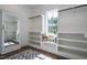 Spacious walk-in closet with built-in shelving, mirror, and window seating at 476 Mollie Meadow Dr, Zebulon, NC 27597
