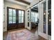 Inviting foyer featuring a large front door, a stylish rug, and a view into the living room at 476 Mollie Meadow Dr, Zebulon, NC 27597