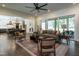 Spacious living room with a gray sofa, hardwood floors, and views into the kitchen and dining area at 476 Mollie Meadow Dr, Zebulon, NC 27597