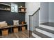 Stylish mudroom featuring a bench, open shelves, and hooks, with a view of the stairs at 476 Mollie Meadow Dr, Zebulon, NC 27597