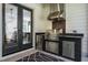 Outdoor kitchen with built-in grill and stainless steel appliances under a covered patio at 476 Mollie Meadow Dr, Zebulon, NC 27597