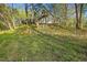 View of backyard with exterior access stairs and natural slope at 5019 Dorsey Rd, Oxford, NC 27565