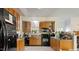 Functional kitchen with oak cabinets and black appliances; ample counter space at 5019 Dorsey Rd, Oxford, NC 27565