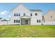 A large backyard with lush green grass and a white picket fence at 514 Bonville Ct, Fuquay Varina, NC 27526