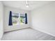 Bright bedroom with neutral walls and plush gray carpeting at 514 Bonville Ct, Fuquay Varina, NC 27526
