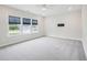 Bright, airy bedroom features three large windows, neutral walls, and plush gray carpeting at 514 Bonville Ct, Fuquay Varina, NC 27526