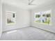 Bright bedroom with neutral carpeting, and backyard view through the windows at 514 Bonville Ct, Fuquay Varina, NC 27526