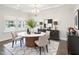 Elegant dining room with stylish lighting, modern furniture, and decorative rug at 514 Bonville Ct, Fuquay Varina, NC 27526