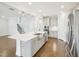 Modern open-concept kitchen featuring stainless appliances, large island, and hardwood floors at 514 Bonville Ct, Fuquay Varina, NC 27526