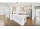 Bright kitchen featuring quartz countertops, stainless steel appliances, and center island at 514 Bonville Ct, Fuquay Varina, NC 27526